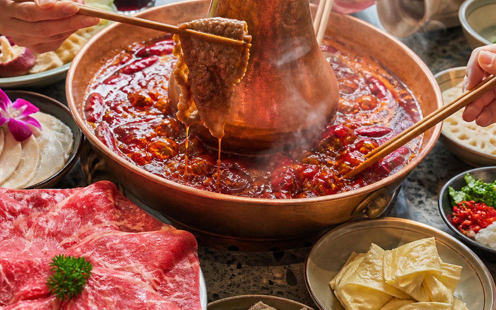Sichuan hotpot brand-atmosphere visual showing a shared red-oil hotpot table