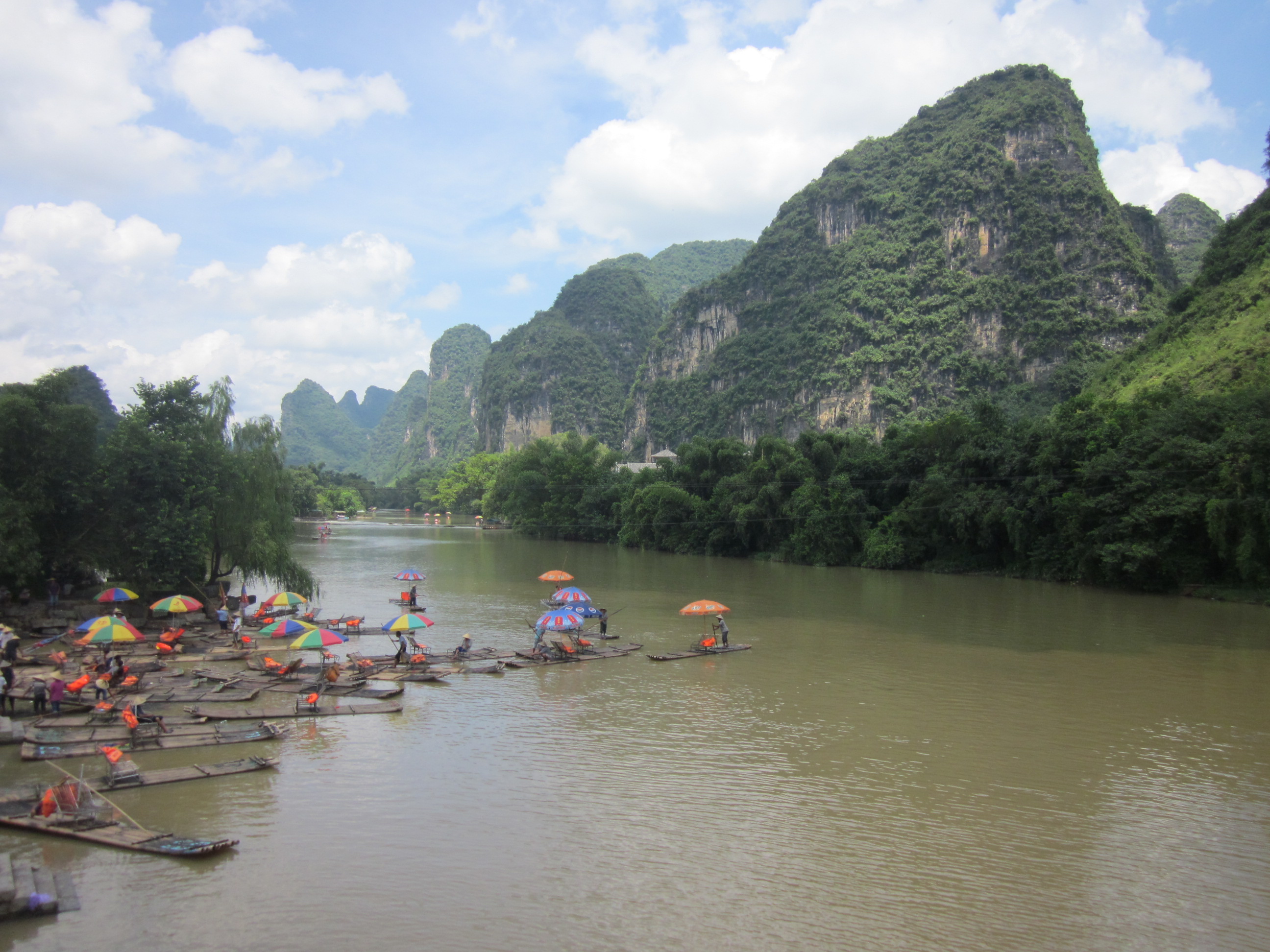 Li River, limestone hills and sightseeing rafts in Yangshuo County